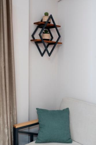 a shelf above a couch with a green pillow at Anastasia's Luxury House in Kavala