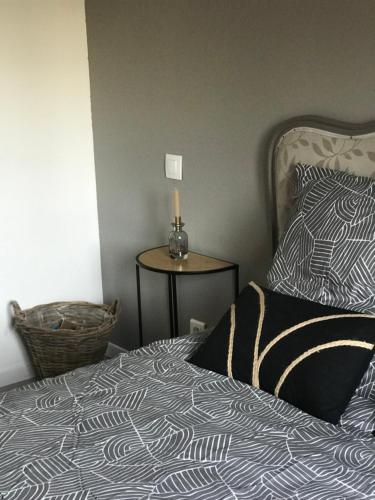 a bedroom with a bed with a candle on a table at Maison 6 chambres in Beauvais