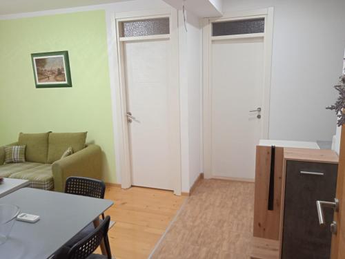 a living room with a couch and a table at SMEŠTAJ SOLARIS kod Aqua Parka SUPERIOR & FAMILY Apartments in Soko Banja