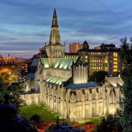 a large building with a clock tower in a city at The Naburn - 3 Bed House with Free Parking & Close to City Centre in Glasgow