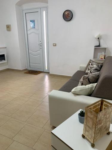 a living room with a couch and a table at Ca' Wanda in Calasetta