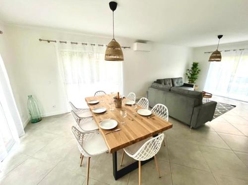 a living room with a wooden table and chairs at Villa Victoria #8 persons #3 Bedrooms #Terrace # garage Beach - Calm and Clim in Roquebrune-Cap-Martin