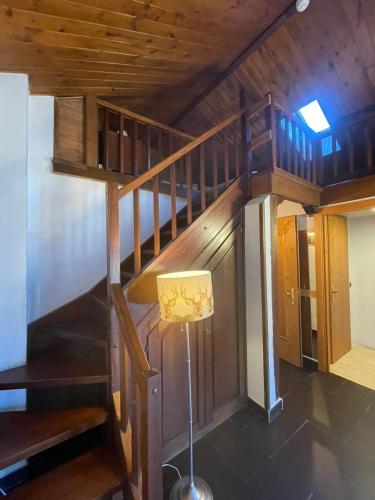 a wooden staircase with a lamp in a room at Hotel Ristorante Il Principe in Claviere