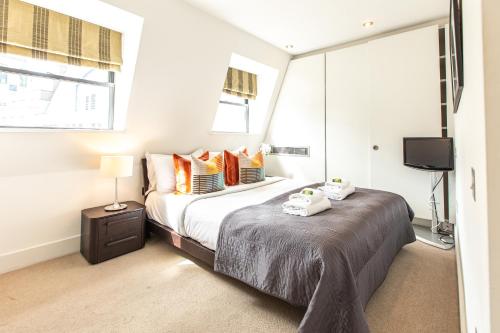 a bedroom with a bed and a tv in it at Contemporary Central London apartments in London