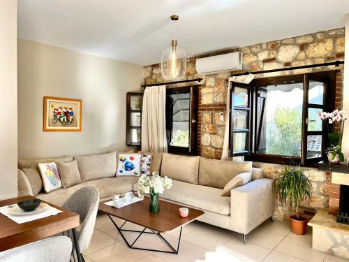 a living room with a couch and a table at Boutique Stone House in Psakoudia