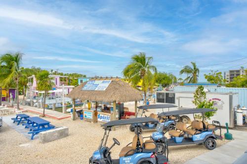 a group of golf carts parked on the beach at Captain Pip's Marina & Hideaway in Marathon