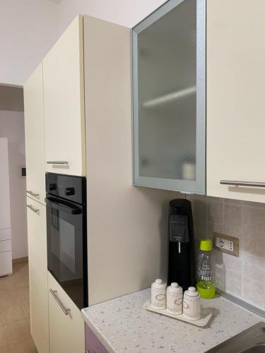 a kitchen with white cabinets and a counter top at Ca' Wanda in Calasetta