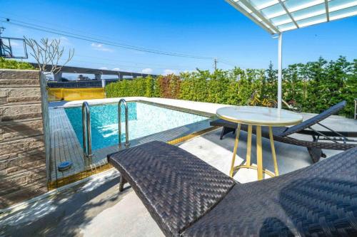 a patio with a table and chairs next to a pool at Wei Yu's Home Villa in Dongshan