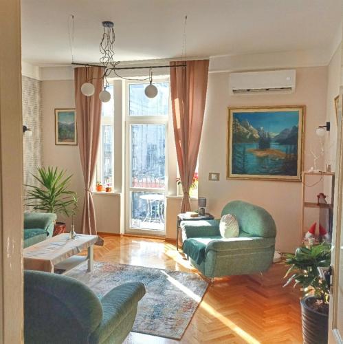 a living room with two chairs and a couch at Gracia apartment - old town Belgrade in Belgrade