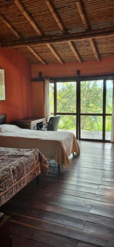 a room with two beds and a laptop on a table at Finca La Colina in Armenia