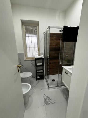 a bathroom with a toilet and a glass shower at Villa Life in San Donato Milanese