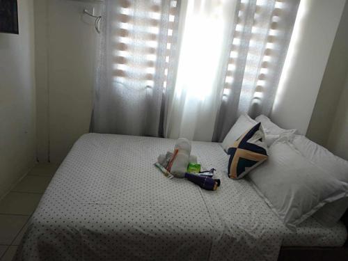 a bedroom with a bed with a window at Pierrecondotel in Manila
