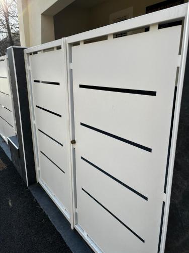 a pair of white garage doors in a driveway at Villa Life in San Donato Milanese
