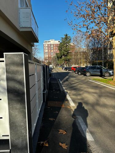 a shadow of a person walking down a street at Villa Life in San Donato Milanese