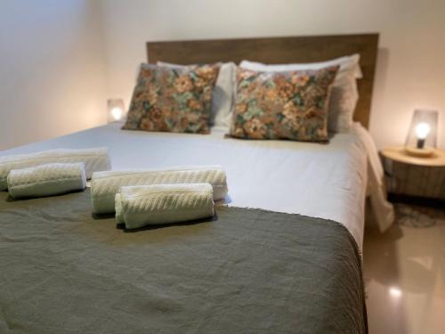 a bedroom with a large bed with two pillows at Casa da Avenida VILLA INN in Braga