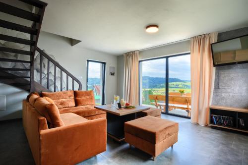 a living room with a couch and a table at Szczytowisko in Grywałd
