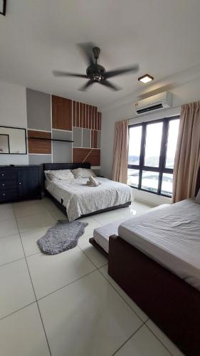 a bedroom with two beds and a ceiling fan at Adore Homestay@Emira Seksyen 13 Shah Alam, MSU, Stadium, AEON Mall in Shah Alam