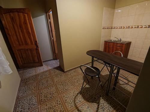 Baño pequeño con mesa y taburete en Mini departamento en hostal, en San Pedro de Atacama
