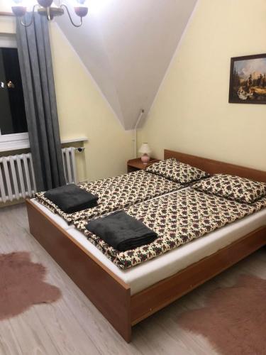 a bedroom with a bed with two pillows on it at U Biela in Poronin