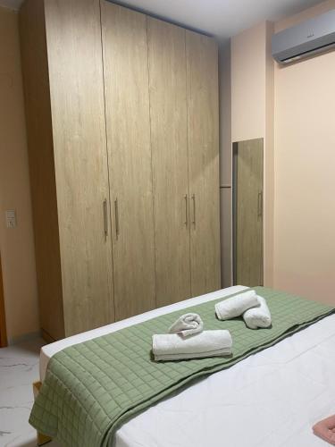 a bedroom with a bed with towels on it at Anastasia's Luxury House in Kavala