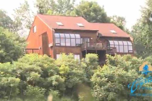 a house on top of a hill with trees at Mountain Creek Condo, Chic, comfy Vernon NJ in Vernon Township