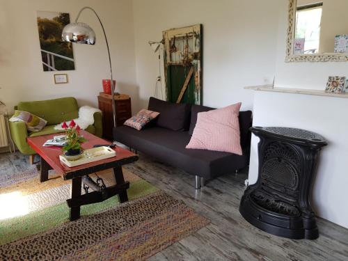 a living room with a couch and a table at Huisjeaandedinkel in Overdinkel