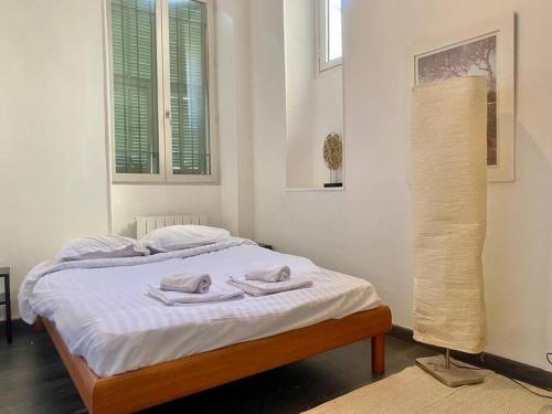 a bedroom with a bed with two towels on it at « Nice et confortable » 2 pièces cozy in Nice