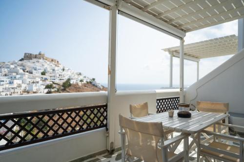 a balcony with a table and a view of positano at Kallichoron Art Boutique Hotel in Astypalaia Town