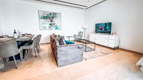 a living room with a couch and a dining table at 360 Nicosia Heights, Gym & Pool in Nicosia