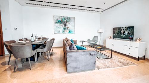 a living room with a table and a dining room at 360 Nicosia Heights, Gym & Pool in Nicosia