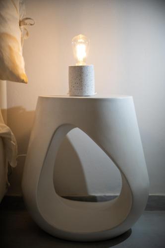 a candle sitting on top of a toilet seat at Kallichoron Art Boutique Hotel in Astypalaia Town