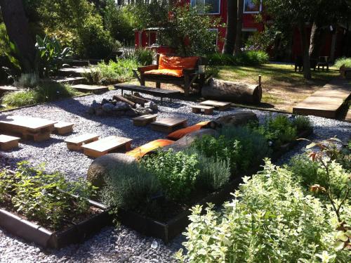 a garden with a bench and a water fall at Cdl in José Ignacio