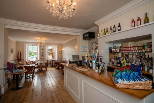 a bar in a restaurant with a dining room at Alexandra Hotel in Weymouth