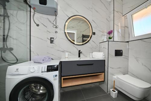 a bathroom with a washing machine and a sink at Luxury Apartment Gloria Old Town Zadar with Sea View in Zadar