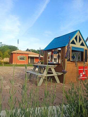 a small house with a picnic table in front of it at Comfeto & Mandolato Sweet Houses in Lakithra