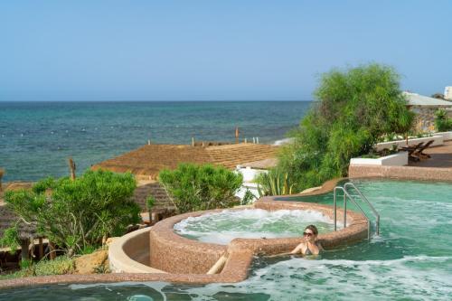 a woman in a hot tub at a resort at Hotel Bel Azur Thalasso & Bungalows in Hammamet