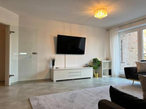 a living room with a flat screen tv on the wall at Maisonette Wohnung Frechen City in Frechen