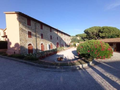 a large building with a road in front of it at Affitti Brevi Toscana - 50 passi dal mare Superior in Fonteblanda