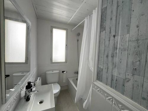 a white bathroom with a sink and a toilet at Apartamento Eguzkilore. Logroño in Logroño