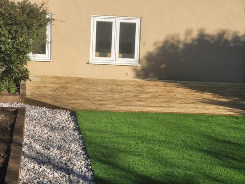 a house with a yard with green grass at Gardeners Cottage near the Norfolk Coast in Knapton