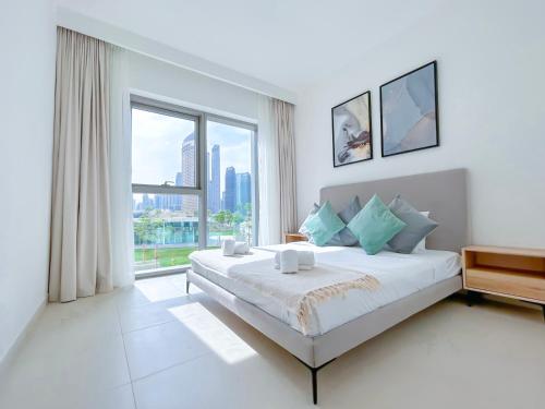 a bedroom with a large bed with a large window at Stunning 2Bedroom with balcony Dubai Mall access in Dubai