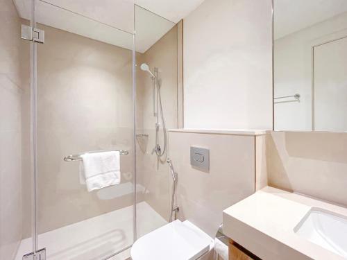 a bathroom with a shower and a toilet and a sink at Stunning 2Bedroom with balcony Dubai Mall access in Dubai