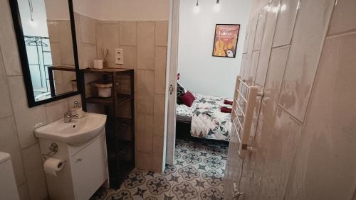 a bathroom with a toilet and a bed at Porta Red in Budapest