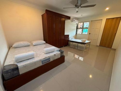 a bedroom with two beds and a table in it at Central KL - Bangsar in Kuala Lumpur