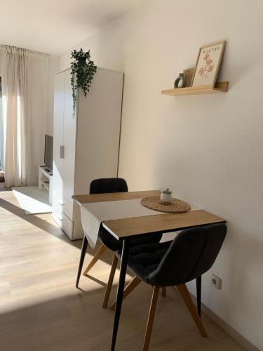 a dining room with a table and two chairs at Ferienwohnung Panorama Schwarzwald in Herrischried