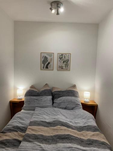 a bedroom with a bed with two lamps on it at Ferienwohnung Panorama Schwarzwald in Herrischried