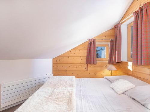 a bedroom with a white bed in a attic at Chalet Avoriaz, 7 pièces, 12 personnes - FR-1-314-230 in Morzine