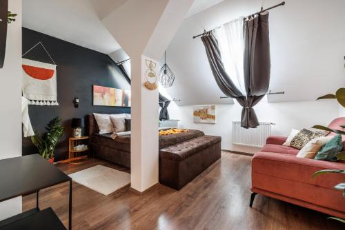 a living room with a couch and a table at Spacious flat & parking possibility, 3 stops to Wenceslav square in Prague