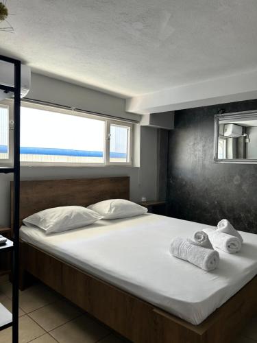 a bedroom with a large bed with towels on it at TheLoft in Kavála