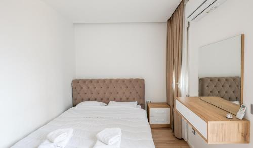 um quarto com uma cama grande e um espelho em Premium Apartment in the Center em Tirana
